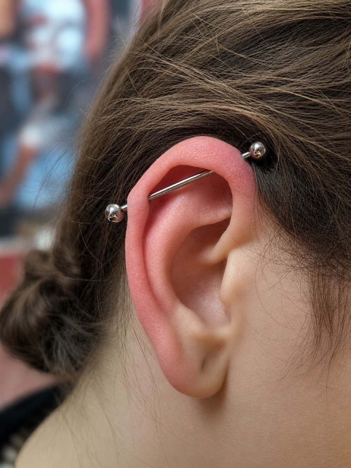 Industrial ear piercing with a straight barbell