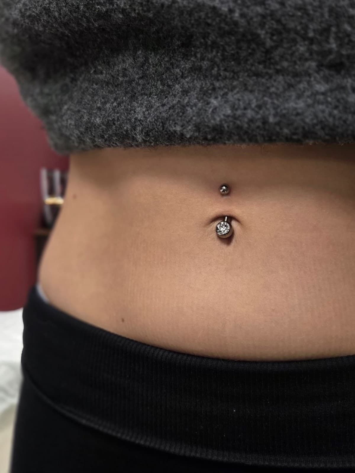 Navel piercing with a clear crystal barbell